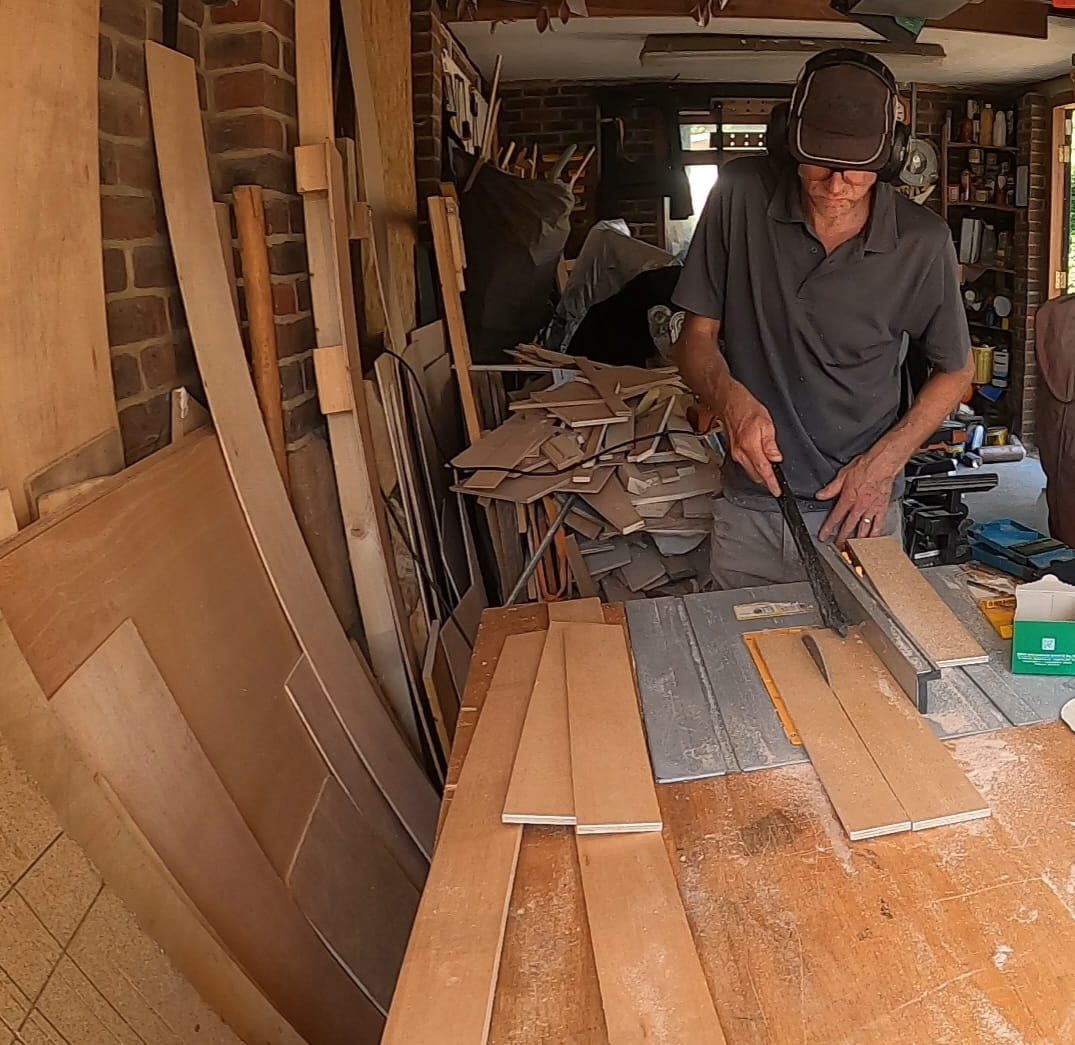 Jason working with timber in the workshop, cutting ply